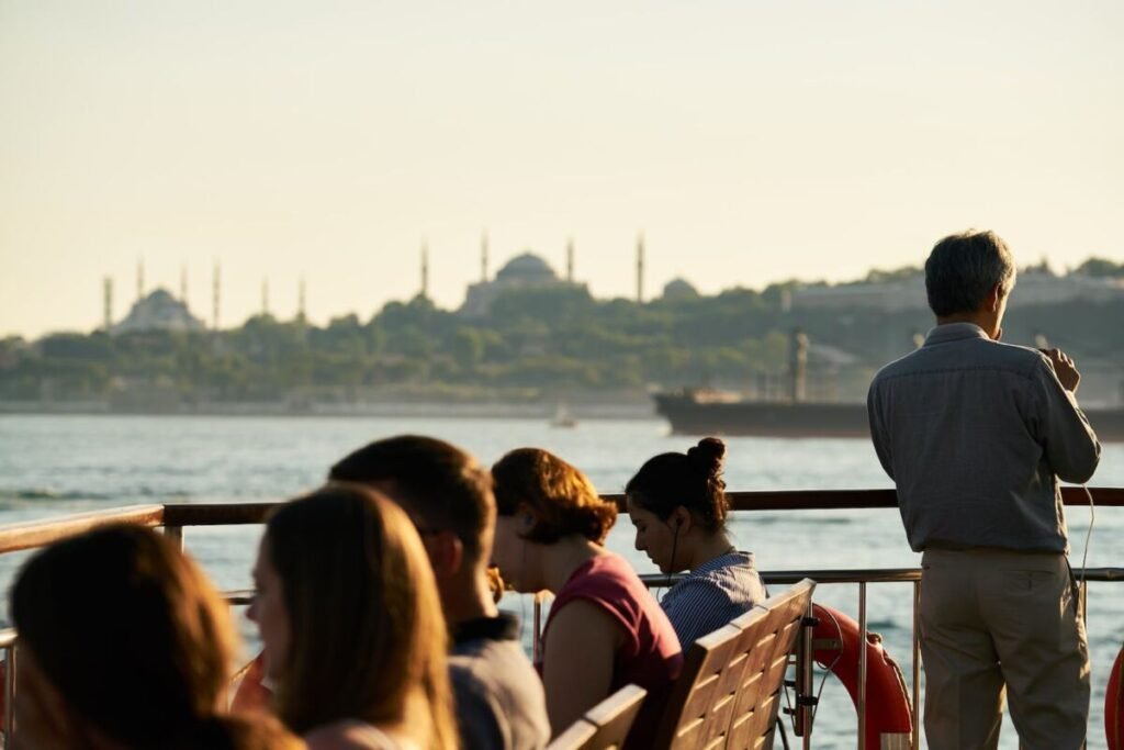 Man Standing Next to People Seated on Benches